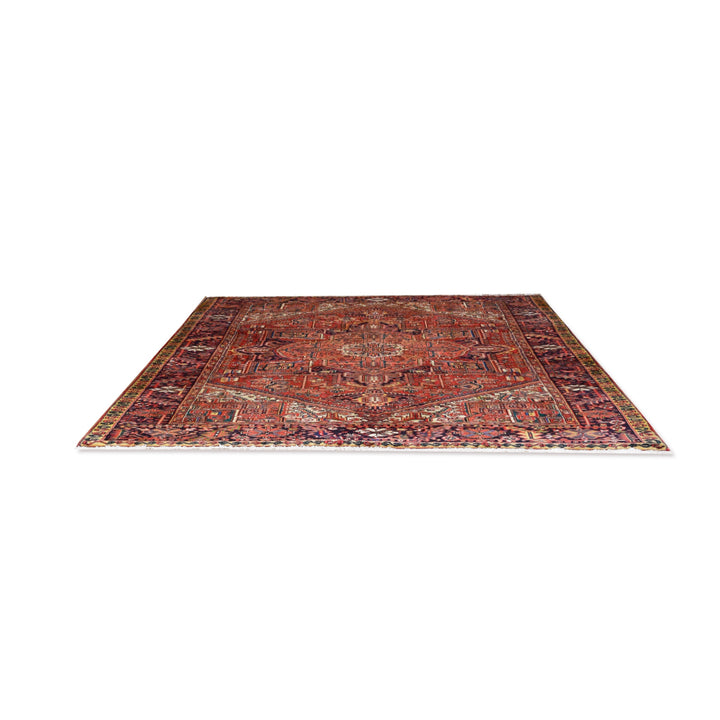 A traditional oriental-style area rug with an intricate floral and geometric pattern, featuring a dominant rust-red center with navy, beige, and brown details, shown flat against a solid white background.